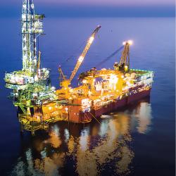 Offshore oil and gas drilling is one of the industries that relies heavily on GDGPS, as workers determine where to drill and where to build platforms, all without visible landmarks, and then must navigate near them, often in rough seas or low visibility. An offshore oil platform is lit up at night